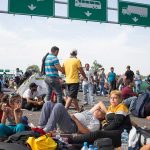 People sitting and resting on a highway.