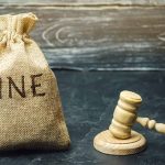 Bag labeled "Fine" next to gavel.
