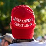 Person wearing a red "Make America Great Again" hat.