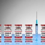 COVID-19 vaccine vials with syringe.