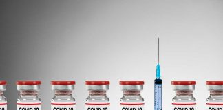 COVID-19 vaccine vials with syringe.