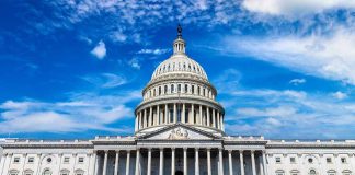 U.S. Capitol building with clear blue sky background.