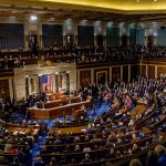 Legislative chamber filled with people during a session