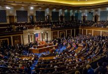 Legislative chamber filled with people during a session