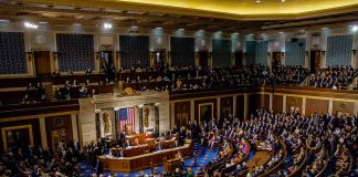 Legislative chamber filled with people during a session