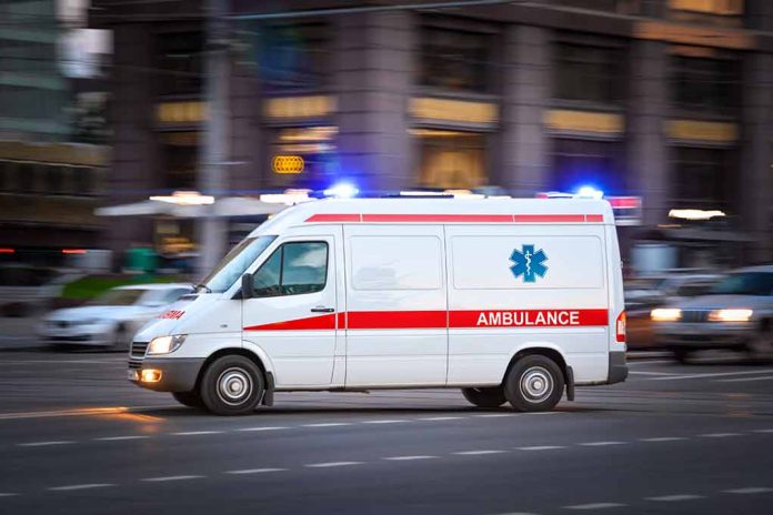 2002660841 featured image Ambulance with lights on driving in city street.