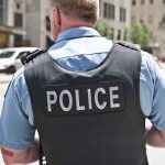 Police officer in uniform standing on city street