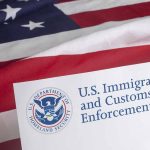 US flag behind Homeland Security document with logo