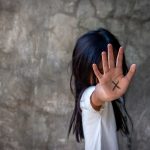 Person with an X on their palm.