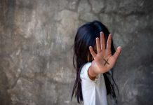 Person with an X on their palm.