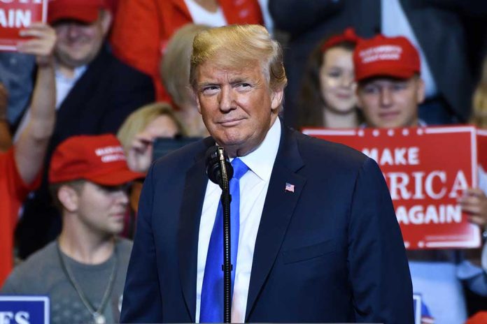 1149680009 featured image Person at a rally with Make America Great Again signs