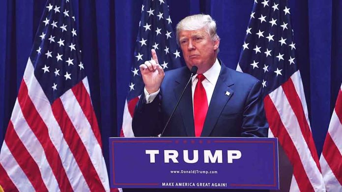 1456399979 featured image Man speaking at podium with USA flags behind him