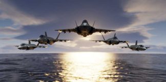 Five fighter jets flying over the ocean at sunset.