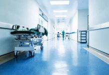 Hospital hallway with a stretcher and medical staff