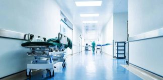 Hospital hallway with a stretcher and medical staff