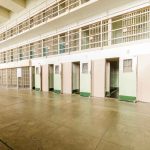 Empty prison cells with open doors two story layout