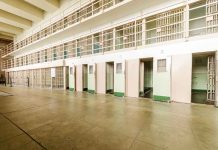 Empty prison cells with open doors two story layout