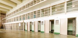 Empty prison cells with open doors two story layout