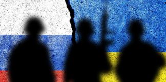 Silhouettes against split Russian and Ukrainian flags