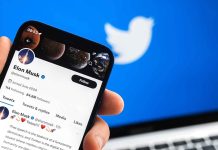 Twitter profile on smartphone screen with Twitter logo background