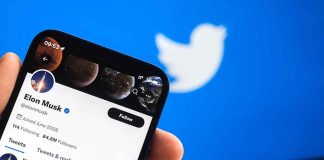 Twitter profile on smartphone screen with Twitter logo background