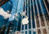 Apple store with glass facade and city reflections