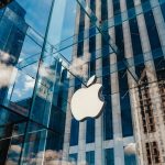 Apple store with glass facade and city reflections