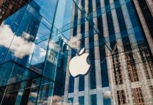 Apple store with glass facade and city reflections