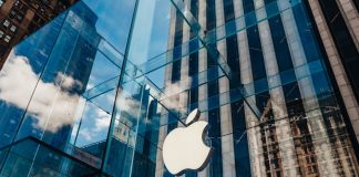 Apple store with glass facade and city reflections