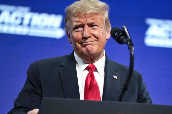 2475617573 featured image Man in suit and red tie at podium.