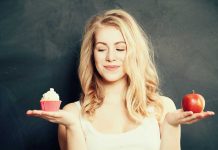 Woman holding a cupcake and an apple