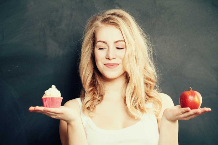 285292964 featured image Woman holding a cupcake and an apple