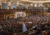 People seated in a large governmental assembly hall