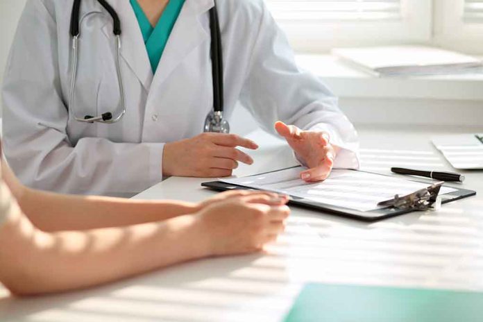 50075309 featured image Doctor discussing with patient holding clipboard on desk