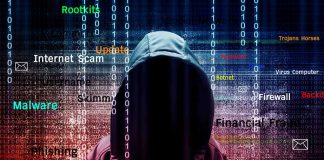 Hooded figure with digital security terms background