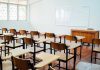 Empty classroom with desks chairs and whiteboard