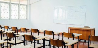 Empty classroom with desks chairs and whiteboard