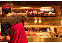Person in red shirt at fried chicken counter