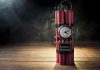 Dynamite bundle with a clock timer on wooden floor
