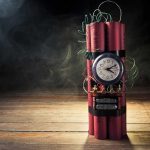 Dynamite bundle with a clock timer on wooden floor