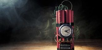 Dynamite bundle with a clock timer on wooden floor