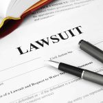 Legal document titled Lawsuit with pen and book