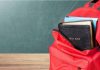Red backpack with Bible and book inside.