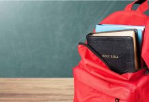Red backpack with Bible and book inside.