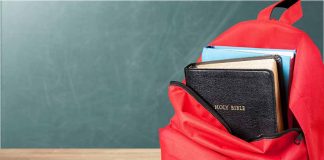 Red backpack with Bible and book inside.