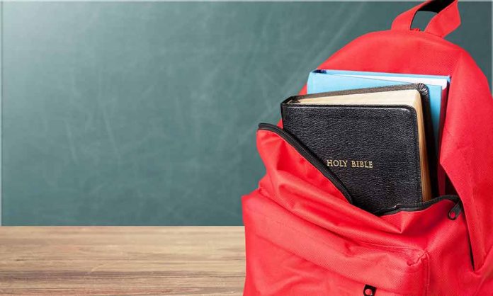 1183389583 featured image Red backpack with Bible and book inside.