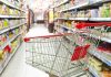 Empty shopping cart in grocery store aisle