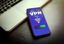 Smartphone displaying VPN app beside a laptop