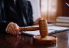 Judge holding gavel in courtroom