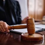Judge holding gavel in courtroom